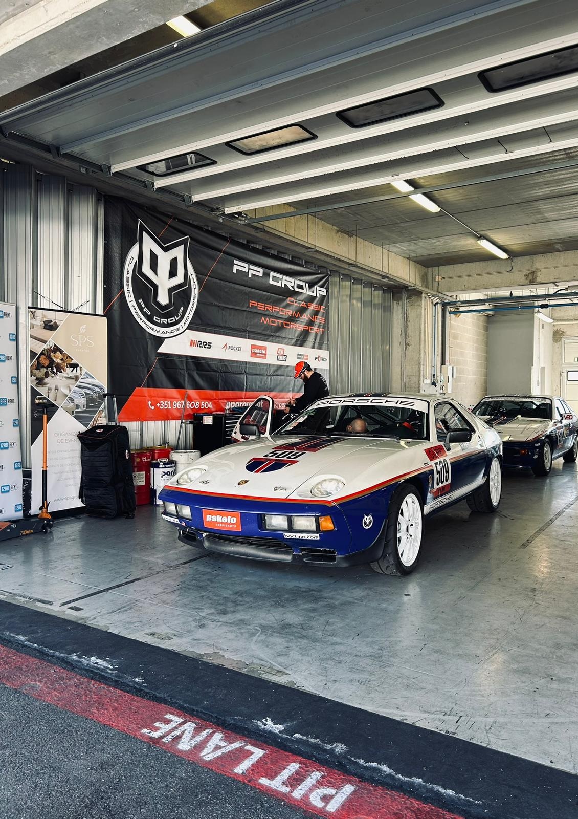Porsche de competição no paddock com a equipa PP Group